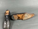 pair of men ' s black leather shoes with laces on them