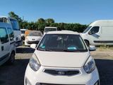 the white car is parked in the parking lot next to other cars