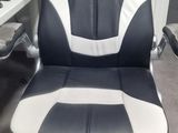a black and white office chair sitting in front of a computer desk