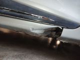 a close up of a car ' s bumper with a hole in it