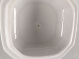 a white bowl with a hole in the middle of it