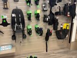 a lot of green and black items on the wall of a store