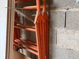 a ladder that is attached to a wall next to a window