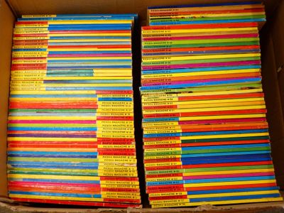 a box full of children ' s books stacked on top of each other