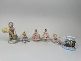 five figurines that are sitting on a table