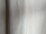 a close up view of a white fabric with a pattern on it