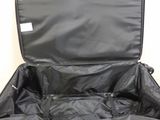 an open black suitcase sitting on top of a white surface