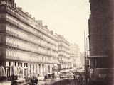 une photo en noir et blanc d'une rue de la ville avec de vieux bâtiments