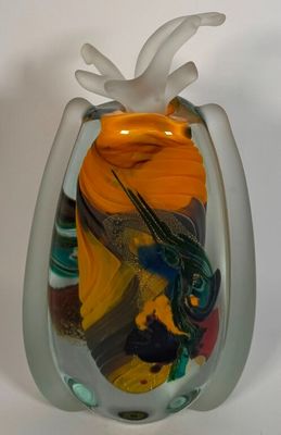 a glass vase with a colorful design on it