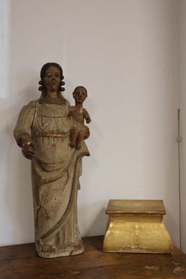 a statue of a woman holding a child on a table