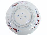 a white plate with blue and red designs on it