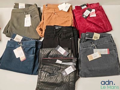 a lot of different colored jeans on a table