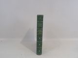 a green book sitting on top of a white table