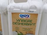 three bottles of vinegar deherrantt sitting on a table