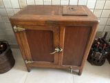 a wooden cabinet with two doors and a wine bottle holder