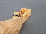 a yellow bow tie with a black tag on it