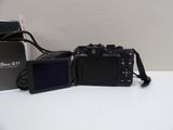 two cameras sitting next to each other on top of a table