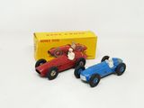 two toy cars sitting next to each other on a white surface