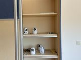 two cameras on the shelves in the room