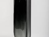 a black vase sitting on a white surface