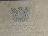 a stone plaque with a coat of arms and a crown on it