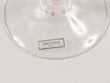 a wine glass with a label on it sitting on a table