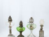 three green glass lamps sitting next to each other on a white surface
