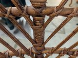 a close up of a wicker chair on a patio