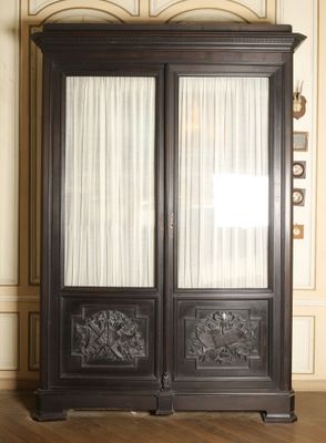a large black cabinet with two doors in a room