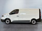 the white van is parked in a room with a gray wall