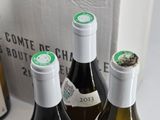 three bottles of wine sitting on a table next to each other