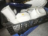 a basket full of dishes and cups on the floor