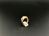 a close up of a gold ring on a black surface