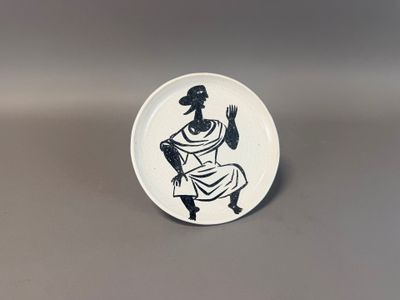 a white plate with a black and white drawing of a woman