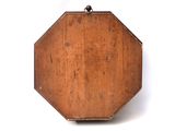 a small wooden box with a handle on a white surface