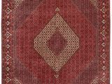 a red rug with a diamond design on it