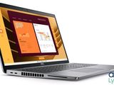 un ordinateur portable ouvert sur une surface blanche