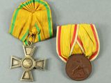 two medals and a medal on a gray surface