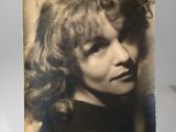 an old photo of a woman with long hair