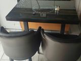two chairs and a table in the corner of a room