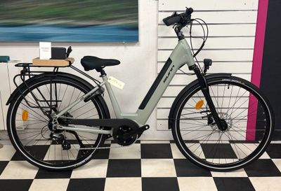 a bike that is parked in a room with a checkered floor