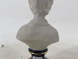 marble bust of a woman on a pedestal with a black base
