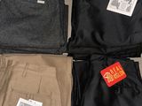 four pairs of men ' s pants on display in a store