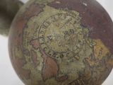 a close up view of a vase with a world map on it