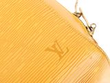 a close up of a yellow louis vuitton purse