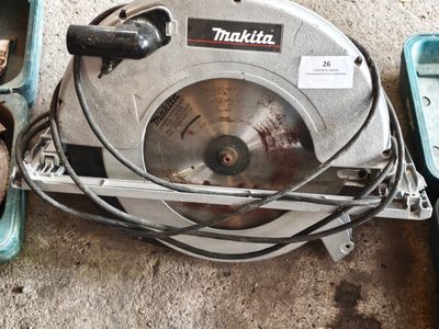 a picture of a circular saw and other tools on the ground