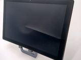 a tablet computer sitting on a stand on a white surface