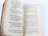 a person holding an open book in their hand