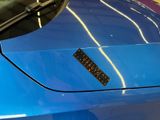 a sticker on the hood of a blue car