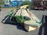 an image of a large green machine in a parking lot